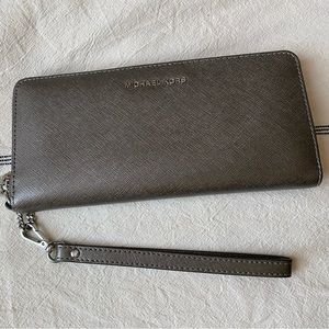 Lightly used grey MK wallet/clutch